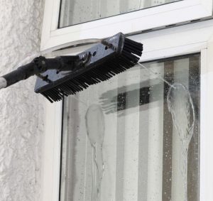 professional-window-cleaning-on-the-outside-with-purified-water-non-retina